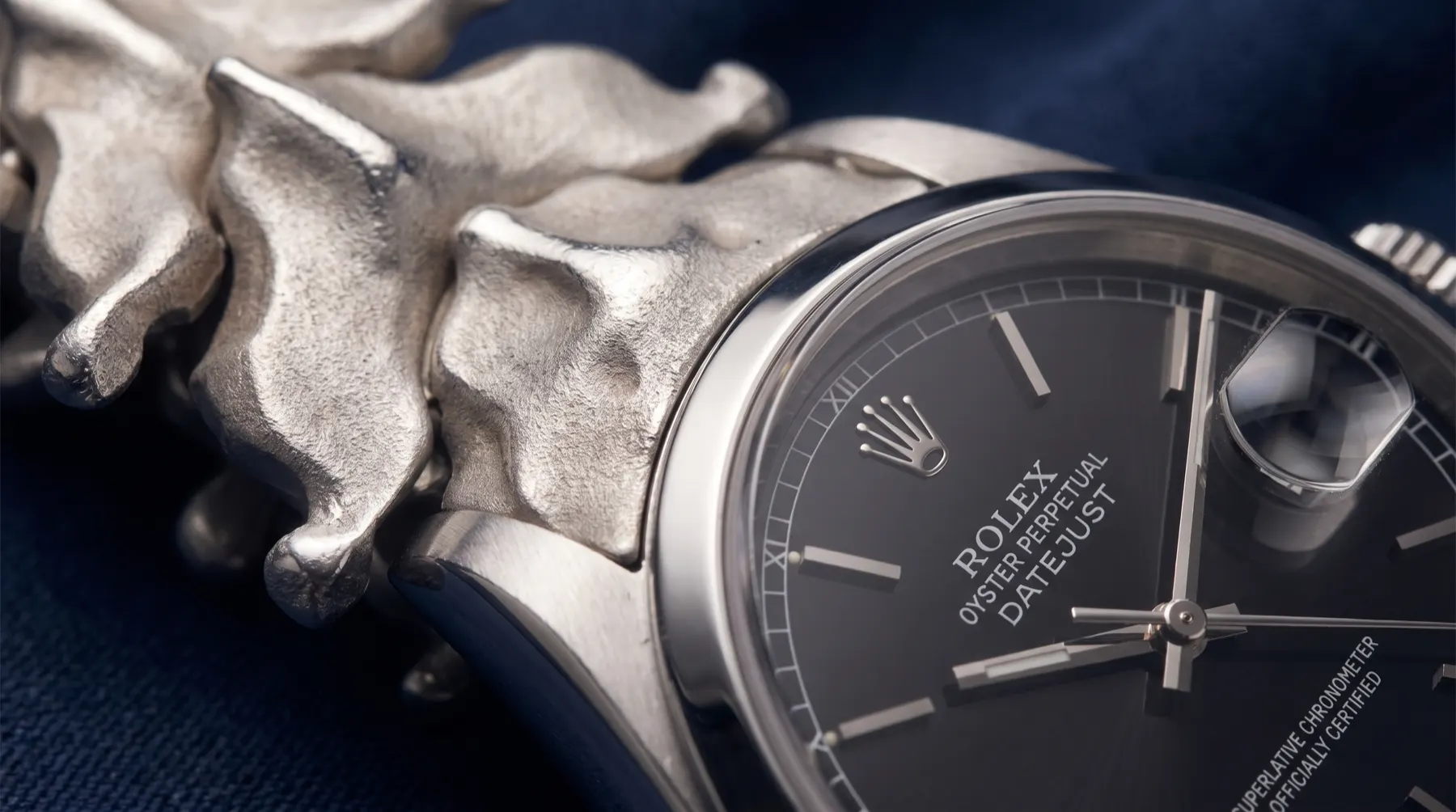 Macro of Datejust dial with sculptural organic bracelet